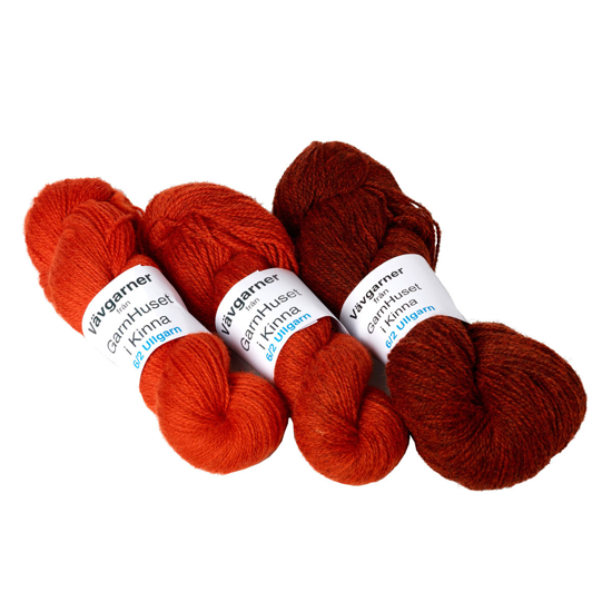 Three skeins of Garnhuset wool 6/2 in autumn colours.