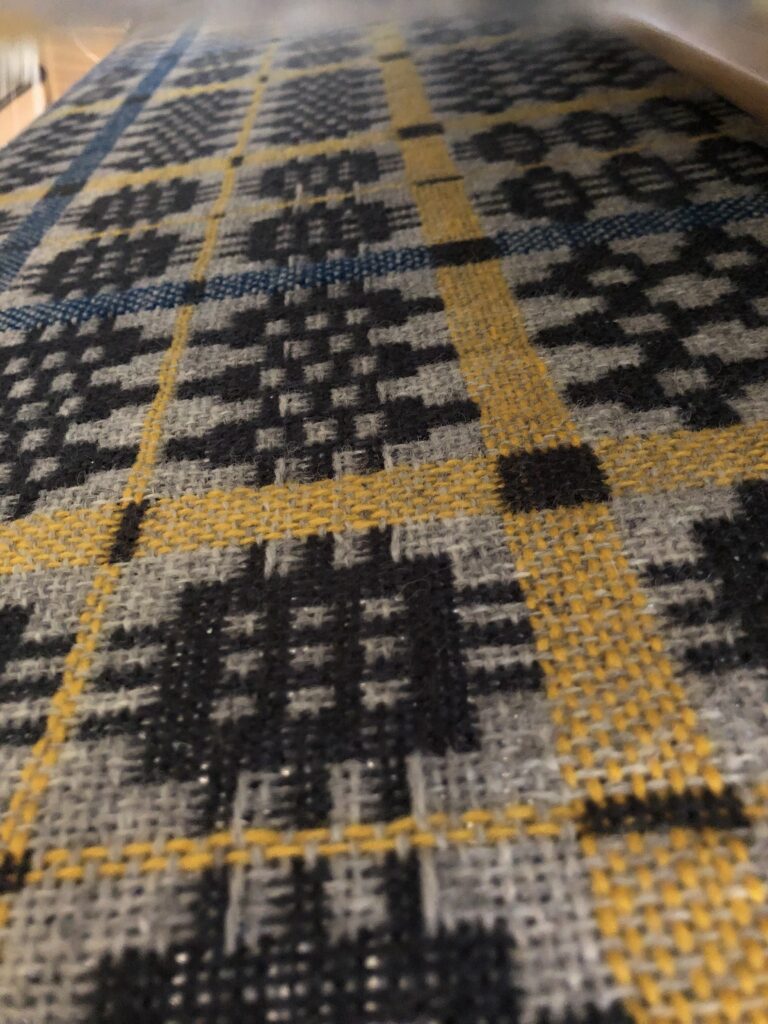 Close-up image of a Welsh blanket on the loom.