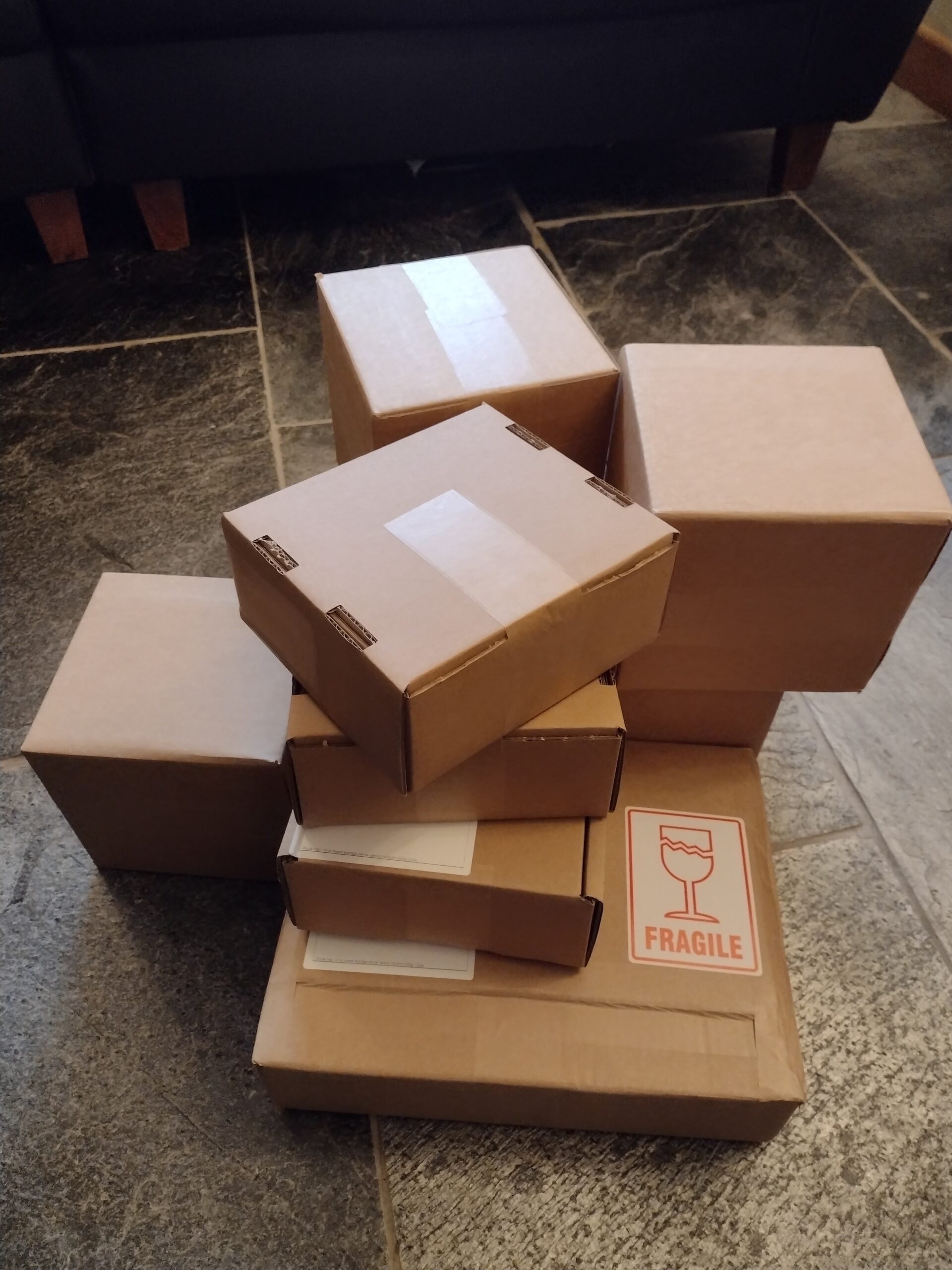 A stack of brown cardboard cartons, packed and ready to post.
